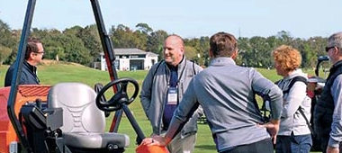 Photo of attendees and partners discussing products outdoors