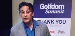 Photo of an attendee standing in front of a sign thanking the Summit's Partners